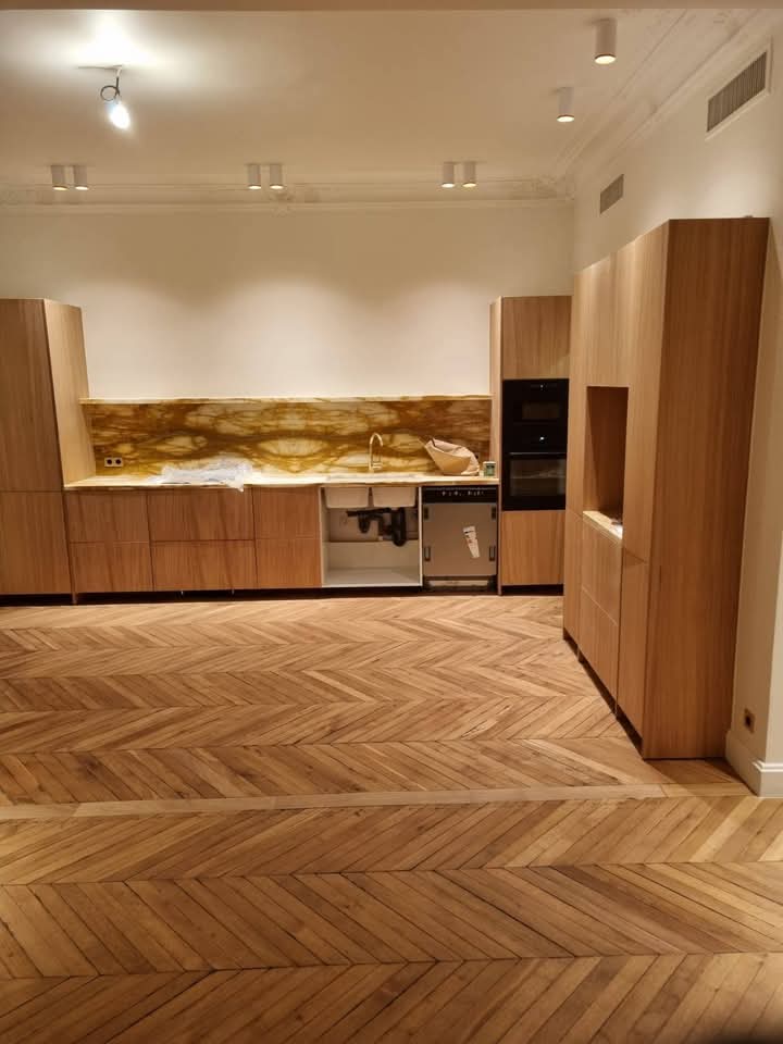 Cuisine sur-mesure en bois clair avec crédence onyx rétroéclairée